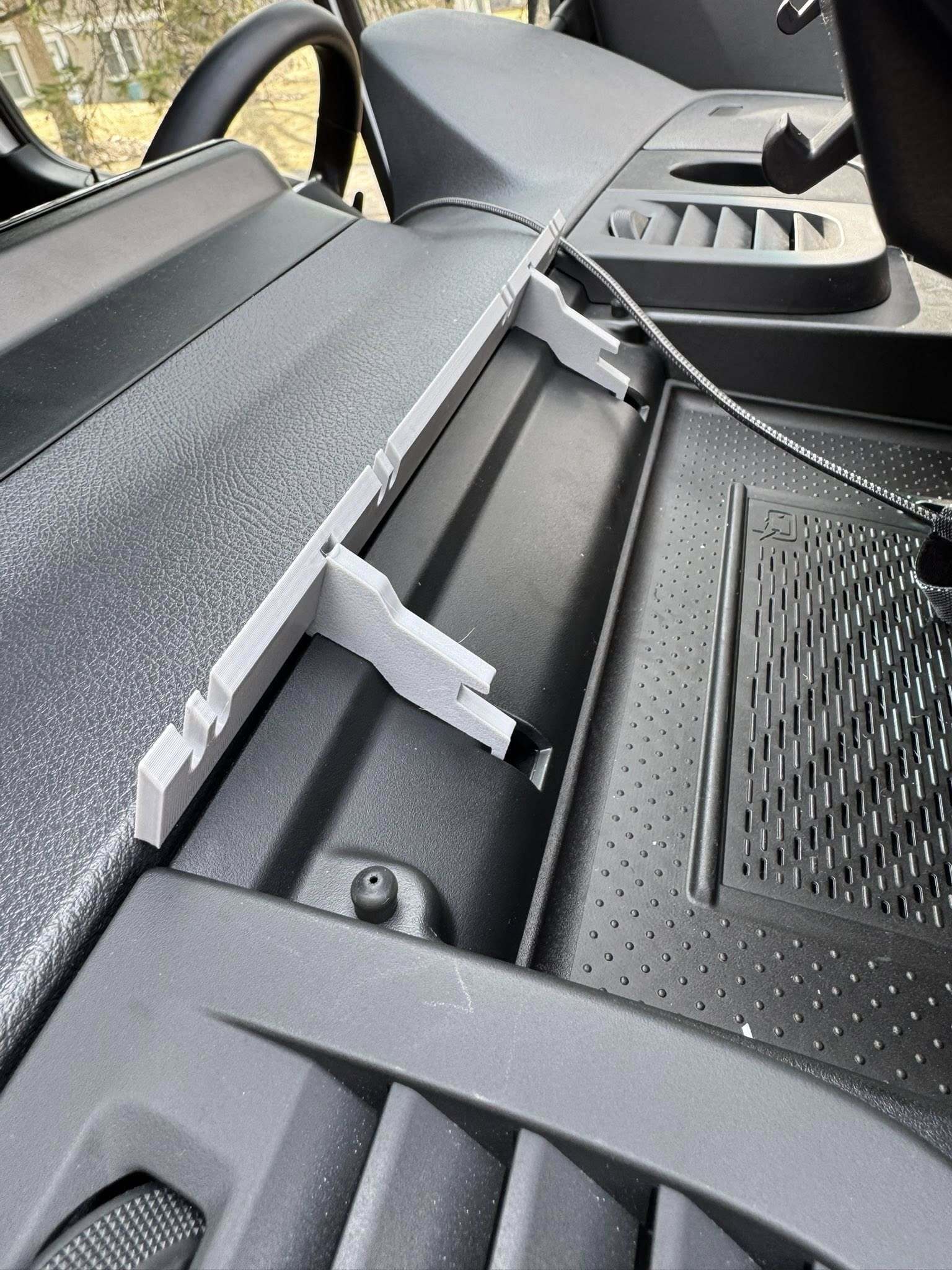 Close-up of a Sprinter's open dashboard compartment with the component in place