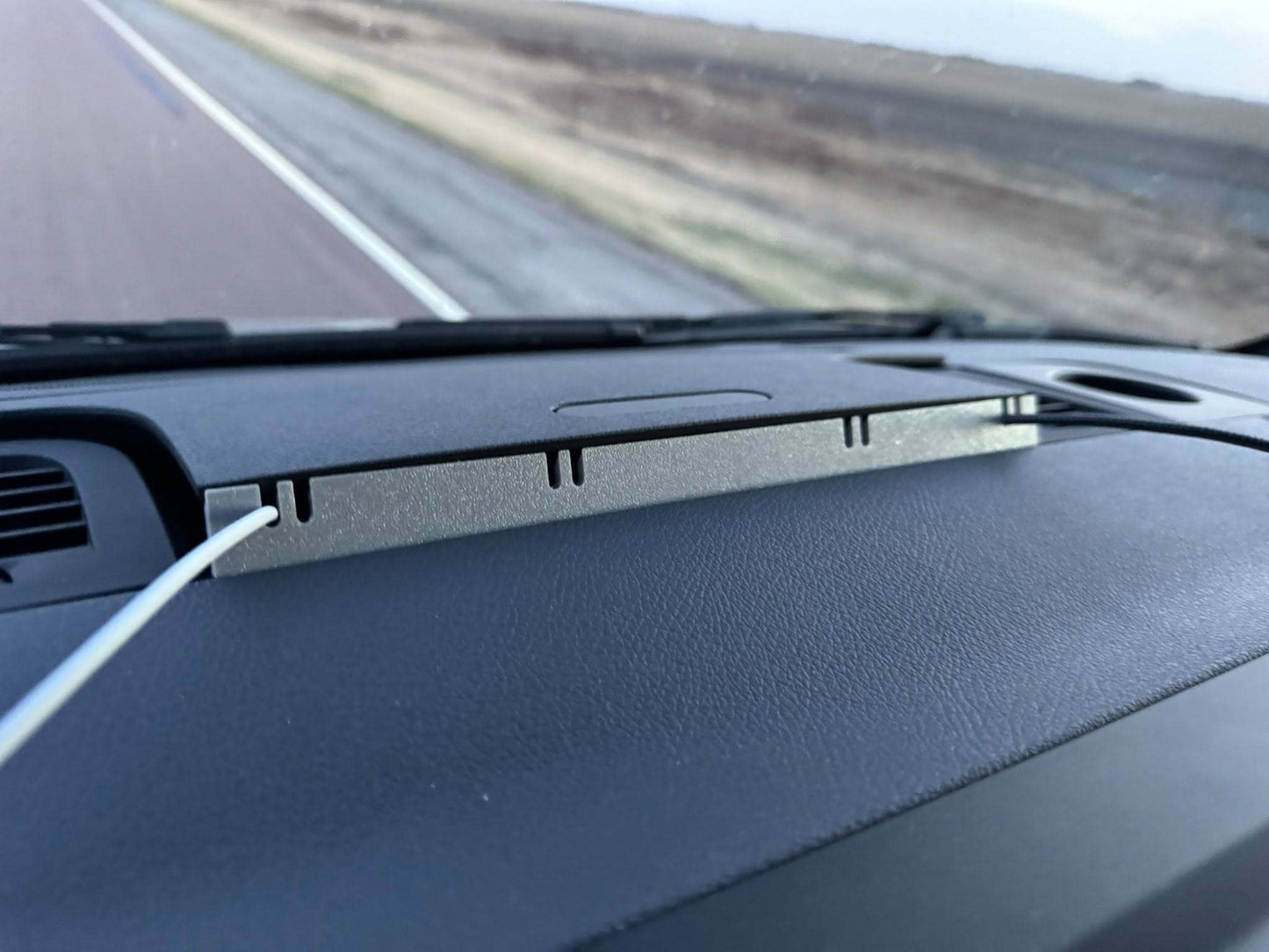Car dashboard with a view of a road ahead